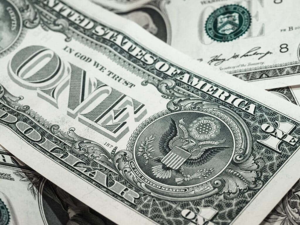 A closeup up of a United States one dollar bill. The photo is being used for an article by Crossroads Investigations, a loan investigator in Florida.